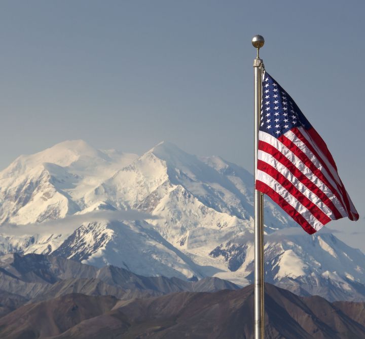 Denali National Park mountain range with american flag. 